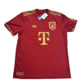 Red sports jersey with gold accents on a white surface