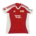 Red sports jersey with white accents on a gray surface