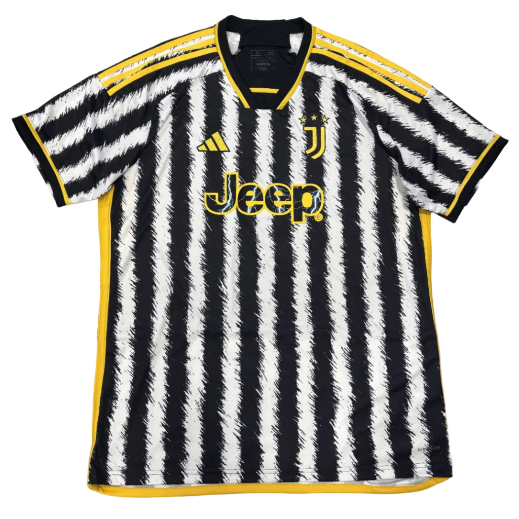 Black and white striped sports jersey with yellow accents on a round surface.