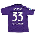 Purple sports jersey with 'Kayode 33' printed on it, displayed on a round white table.