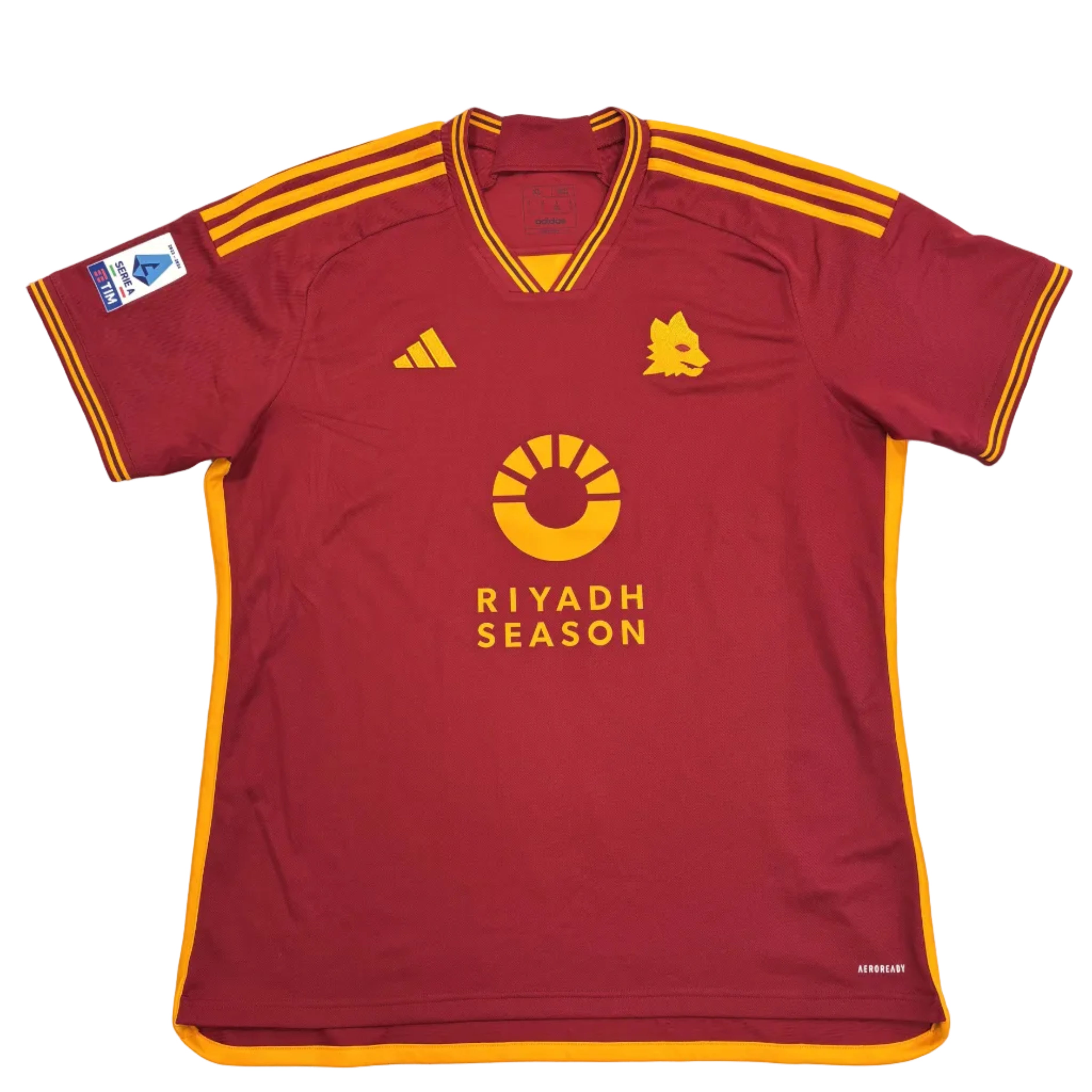 Red sports jersey with yellow accents on a round white table