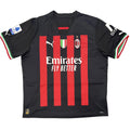 Black sports jersey with red stripes and visible branding on a white surface