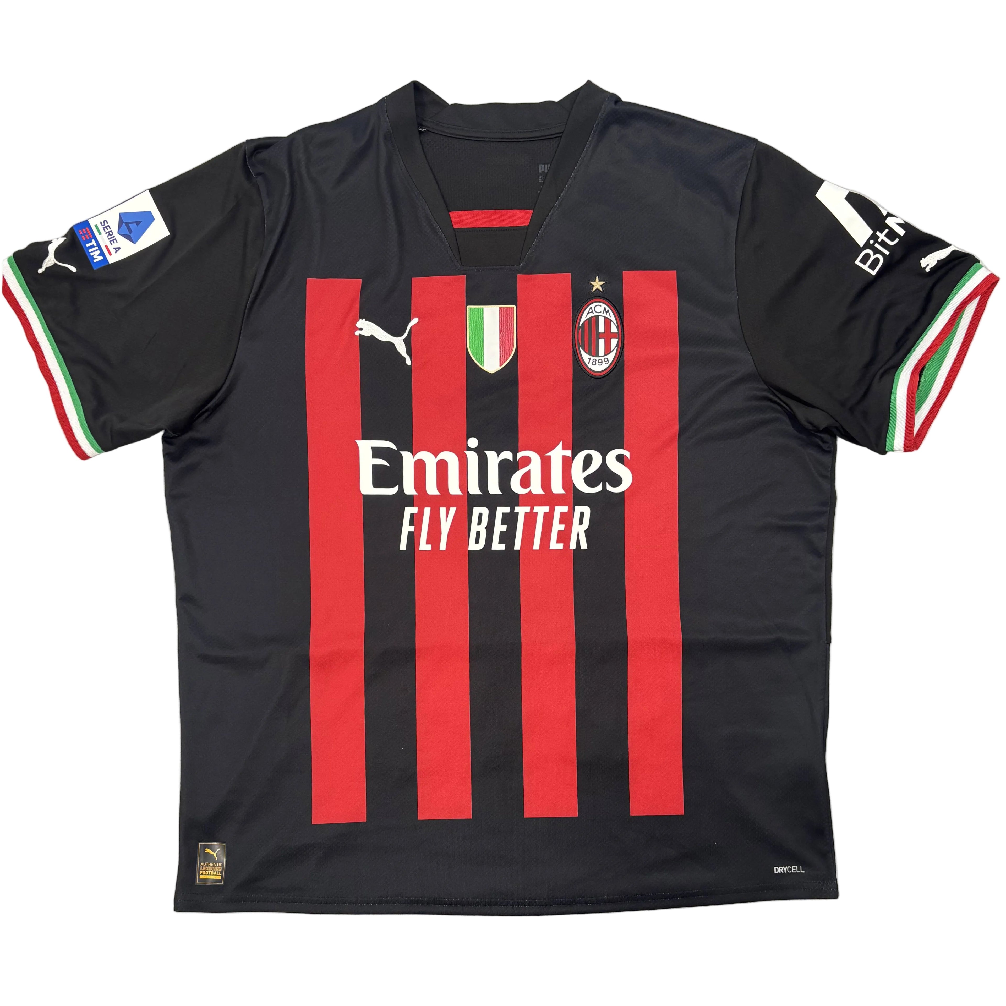 Black sports jersey with red stripes and visible branding on a white surface