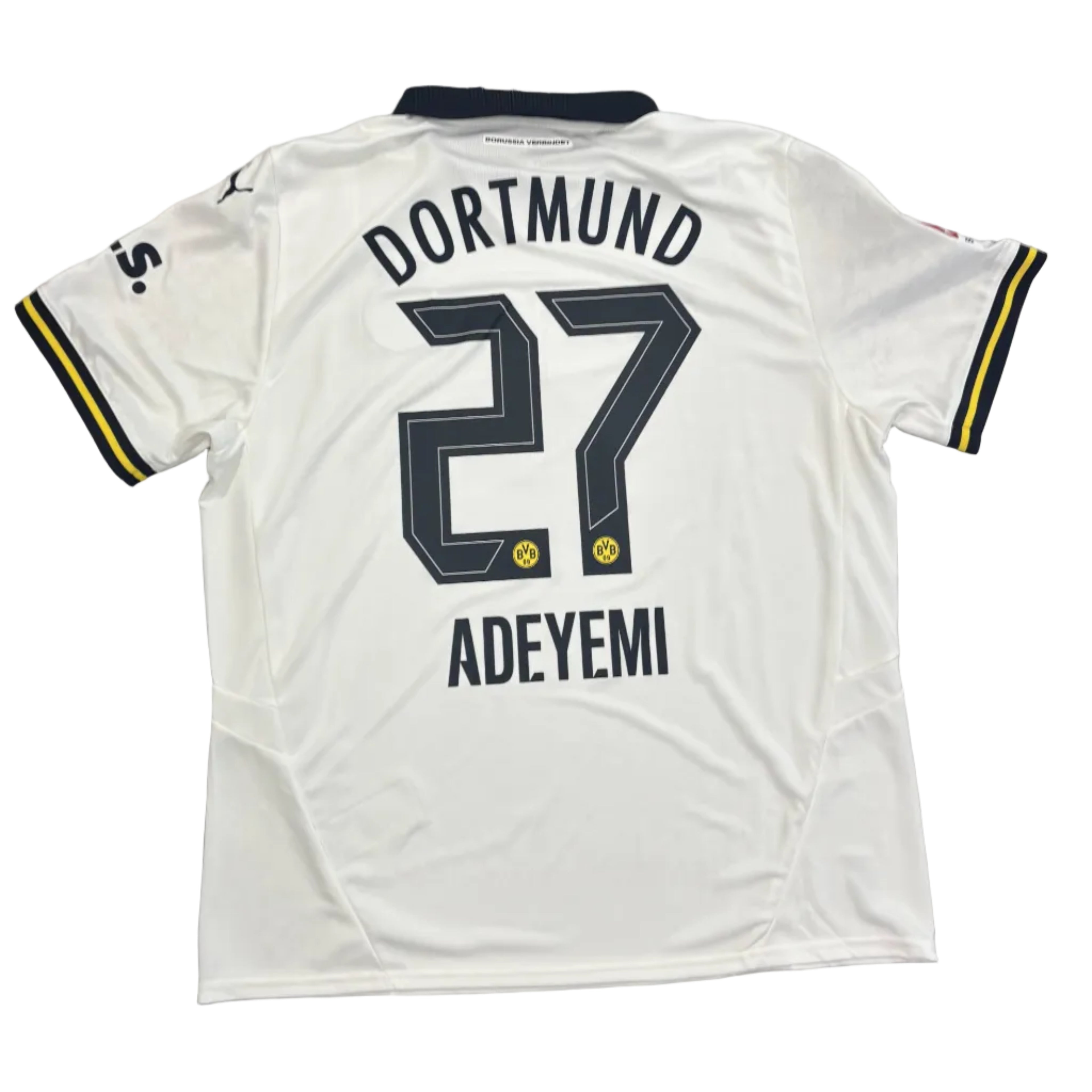 White sports jersey with 'Dortmund 27 Adeyemi' printed on a round table.