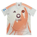 White sports jersey with orange accents on a round gray surface