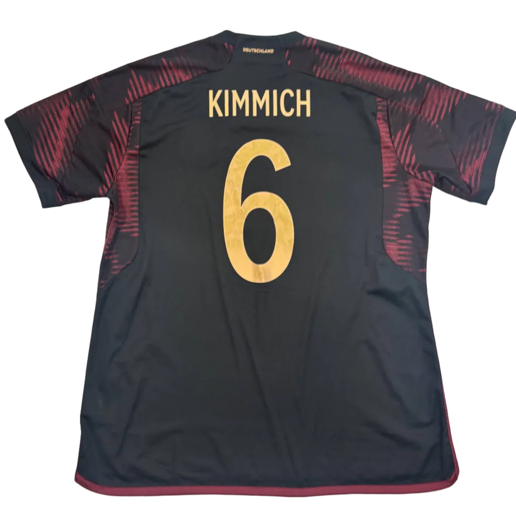 Black sports jersey with 'Kimmich' and number '6' on a white surface