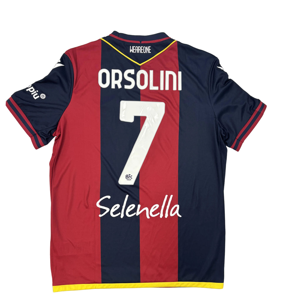 Red and navy sports jersey with 'Orsolini' and number '7' on a white surface