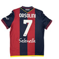 Red and navy sports jersey with 'Orsolini' and number '7' on a white surface