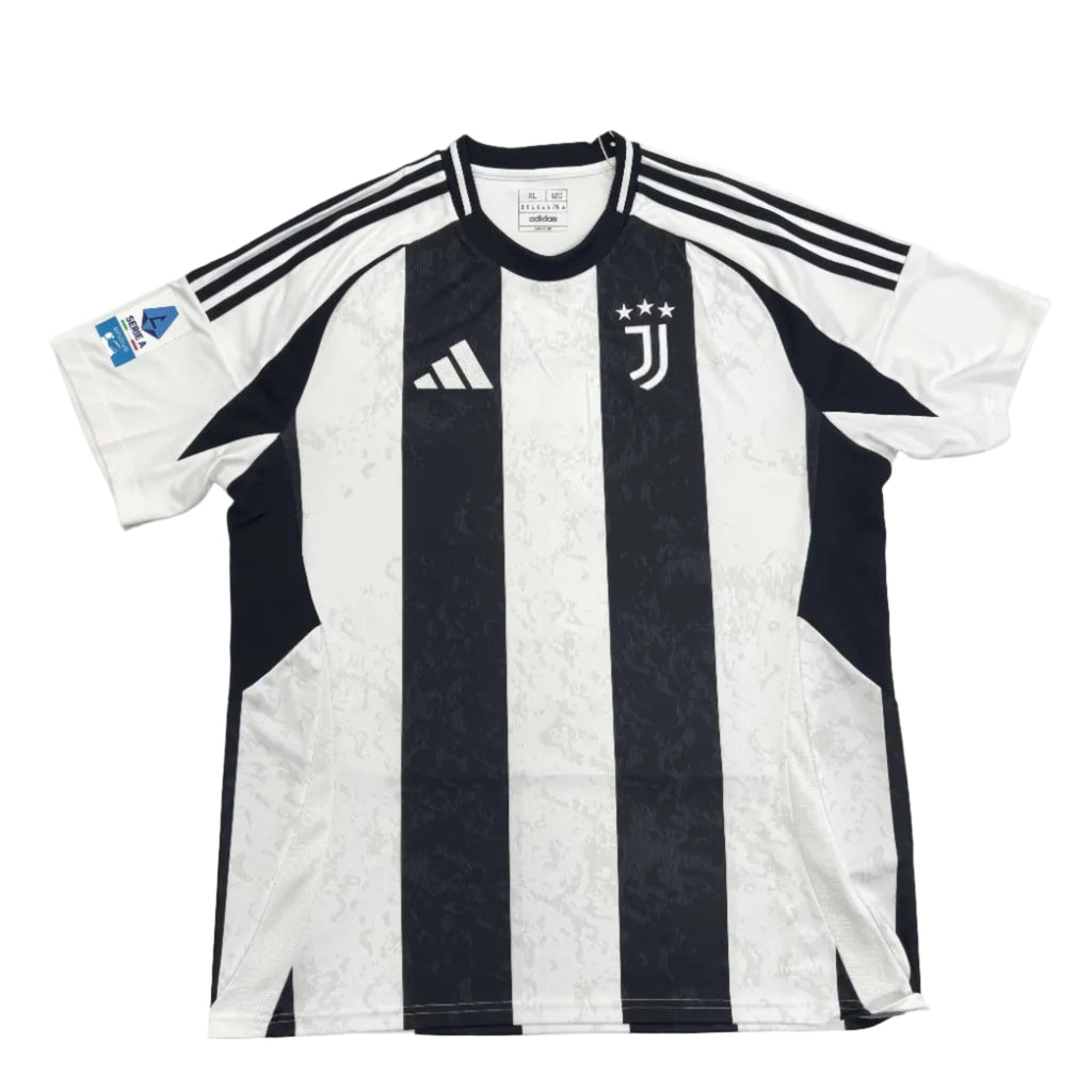 Black and white striped sports jersey with brand logos on a gray surface