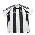 Black and white striped sports jersey with brand logos on a gray surface