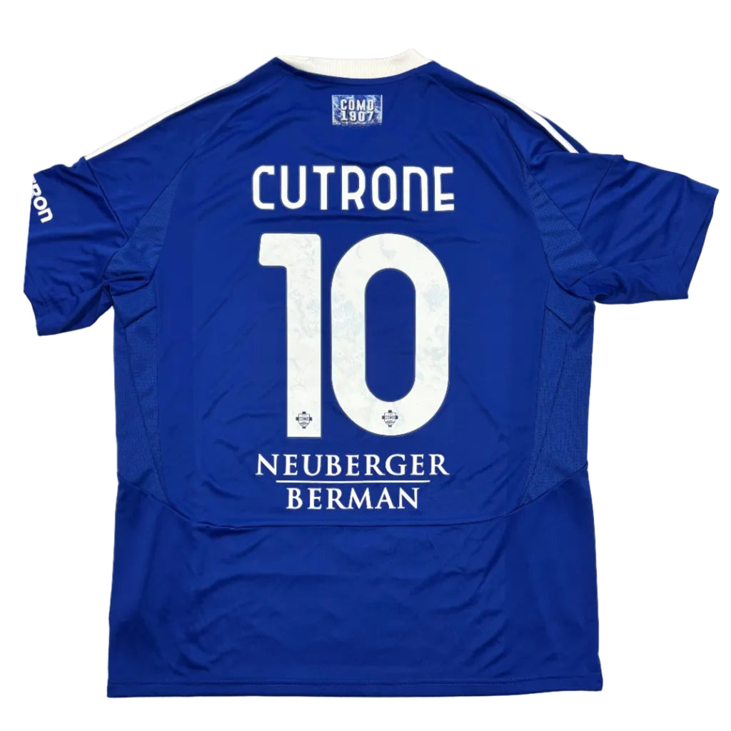 Blue sports jersey with 'CUTRONE 10' printed on the back, displayed on a round table.