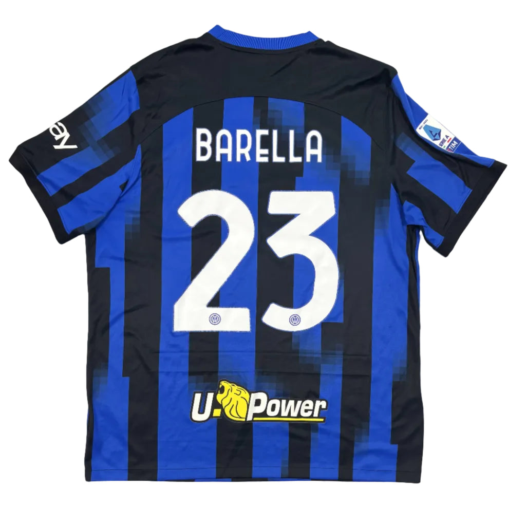 Black and blue sports jersey with 'Barella' and number '23' on a round white table.
