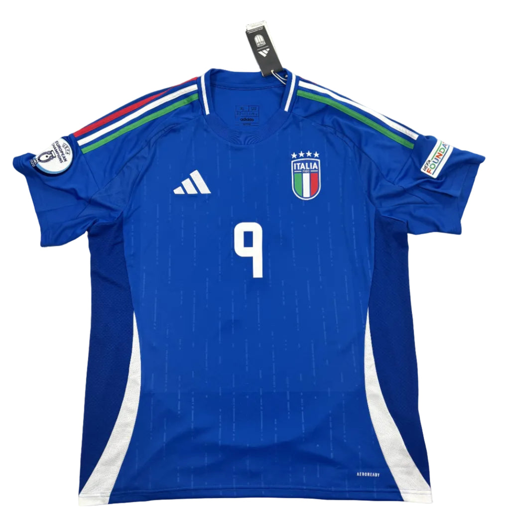 Blue soccer jersey with number 9 on a white surface
