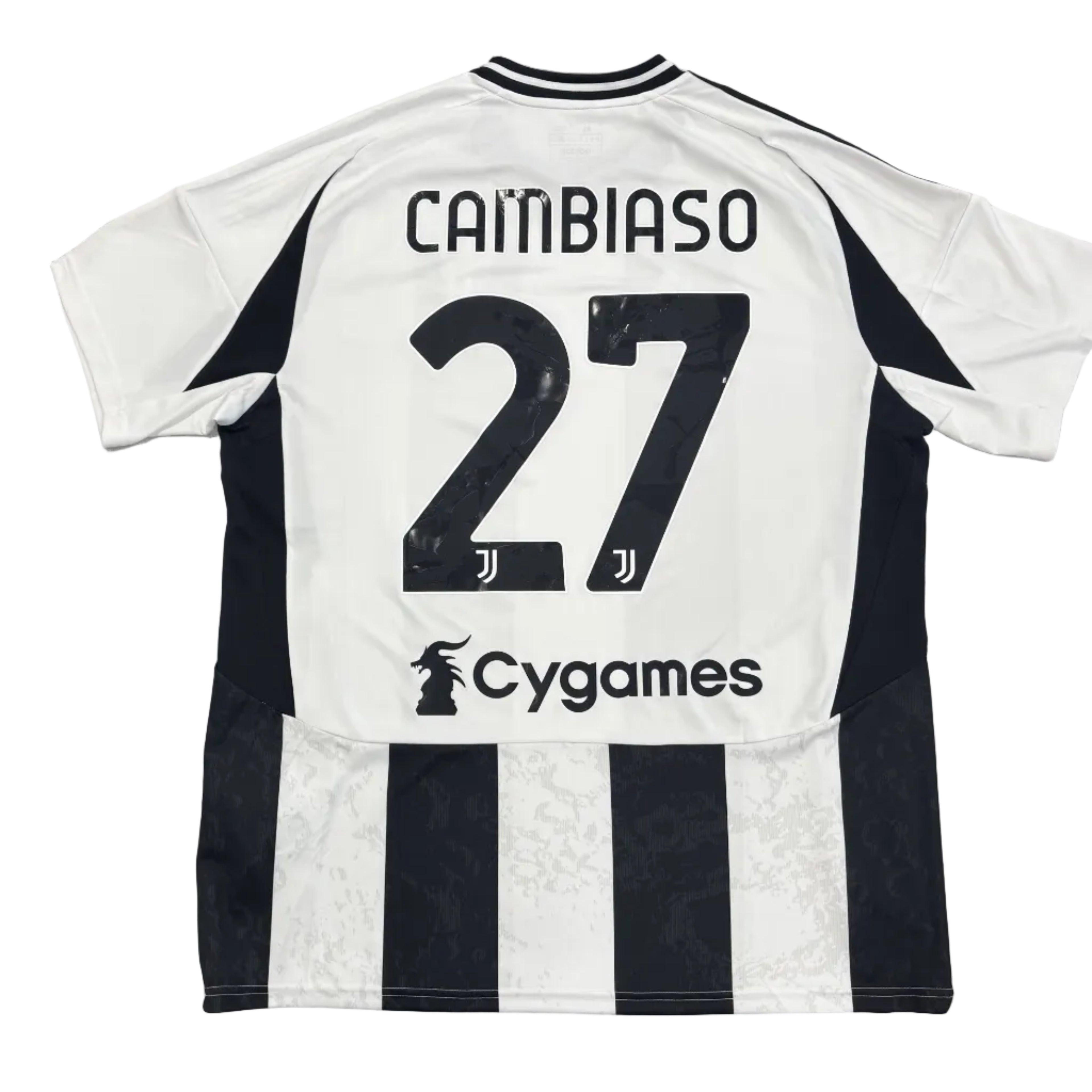 Black and white striped sports jersey with 'Cambiasso 27' on a round table.