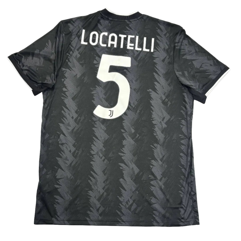Black sports jersey with 'Locatelli' and number '5' on a white surface