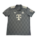 Gray Adidas polo shirt with a logo on a round white table