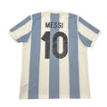 Blue and white striped sports jersey with 'Messi 10' on a round gray surface.