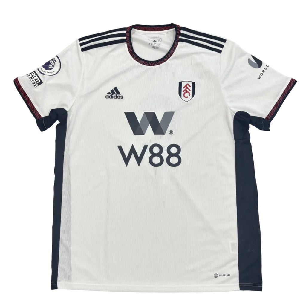 White sports jersey with black accents and branding on a round surface.