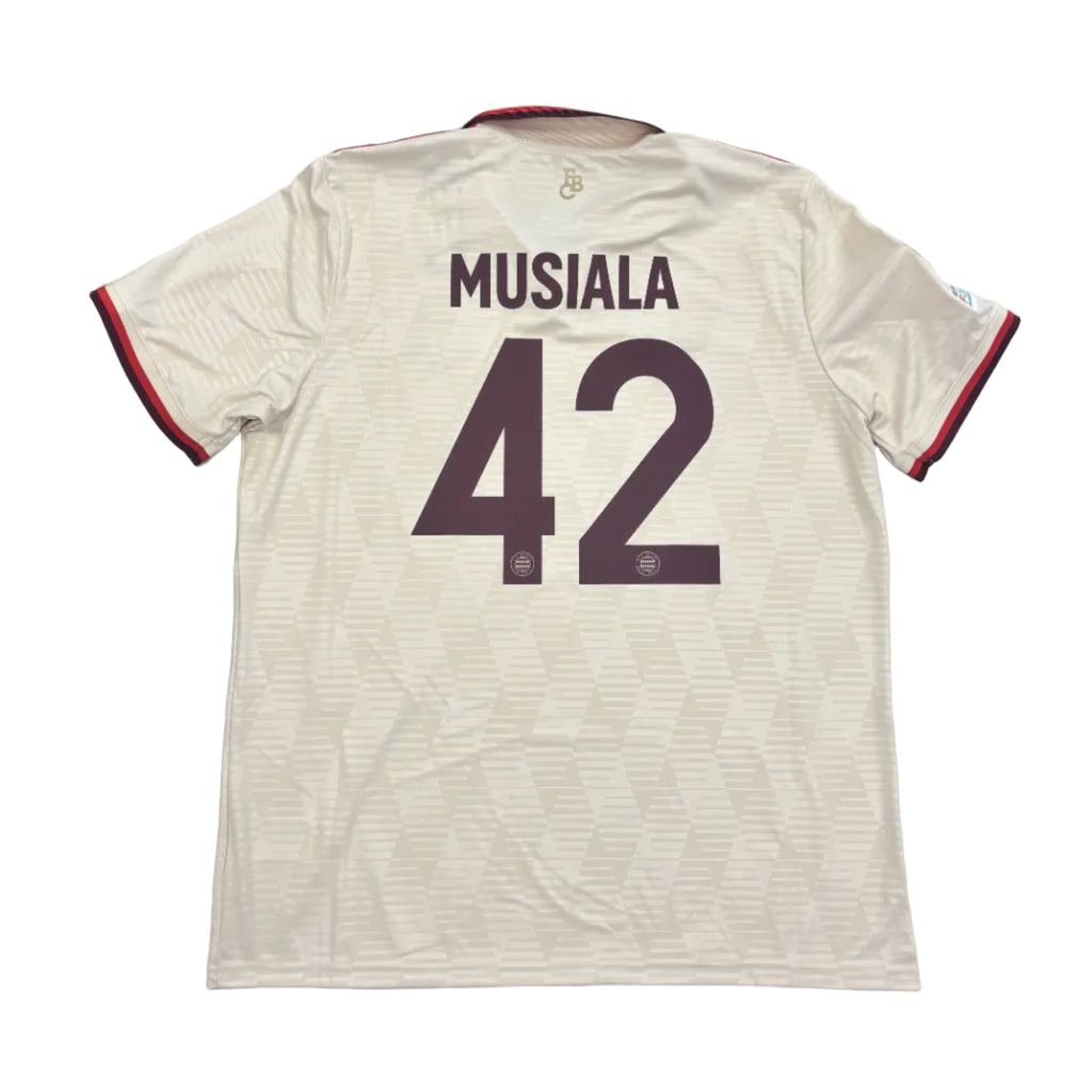 Beige sports jersey with 'Musiala' and number '42' on a round surface.