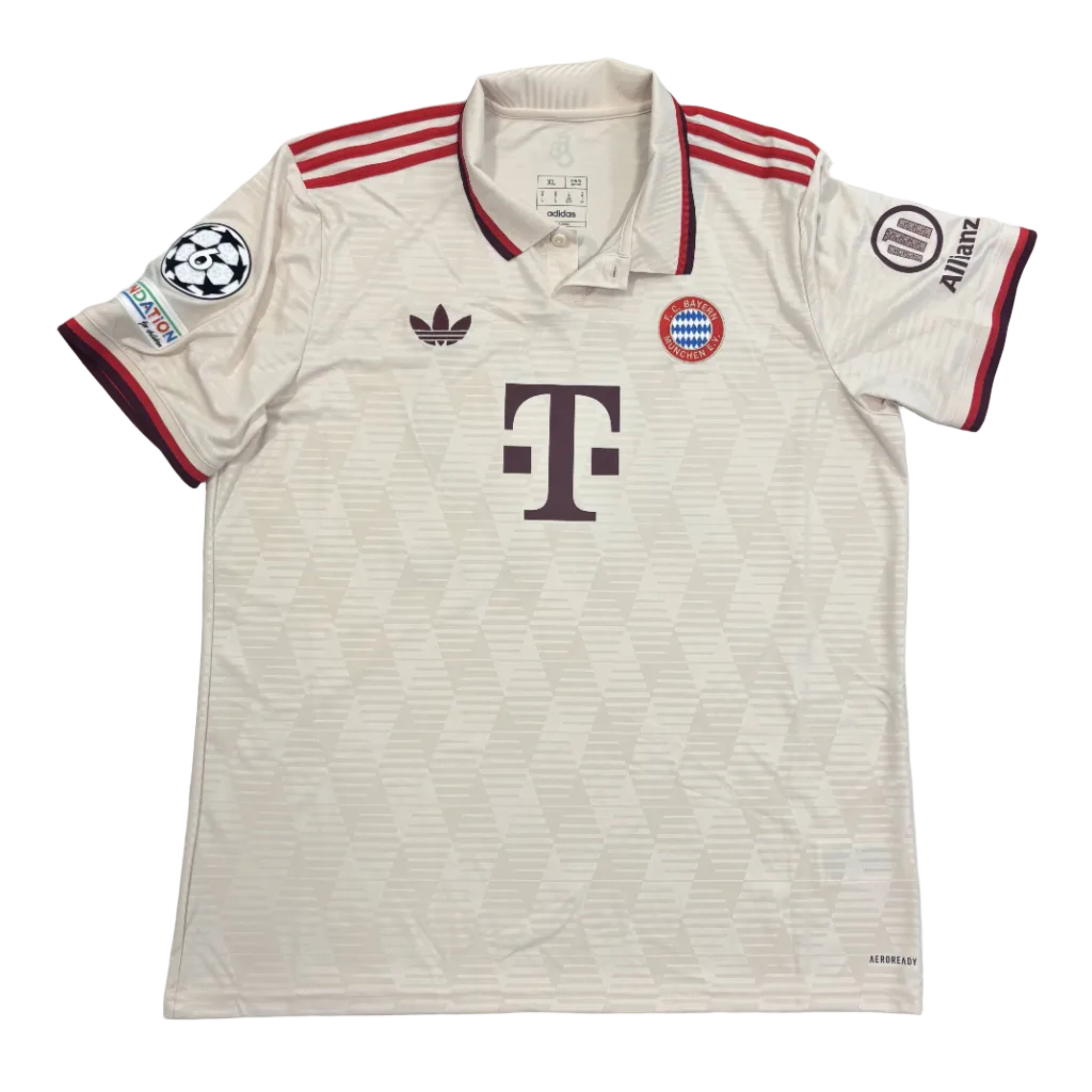 Beige sports jersey with red accents on a gray surface
