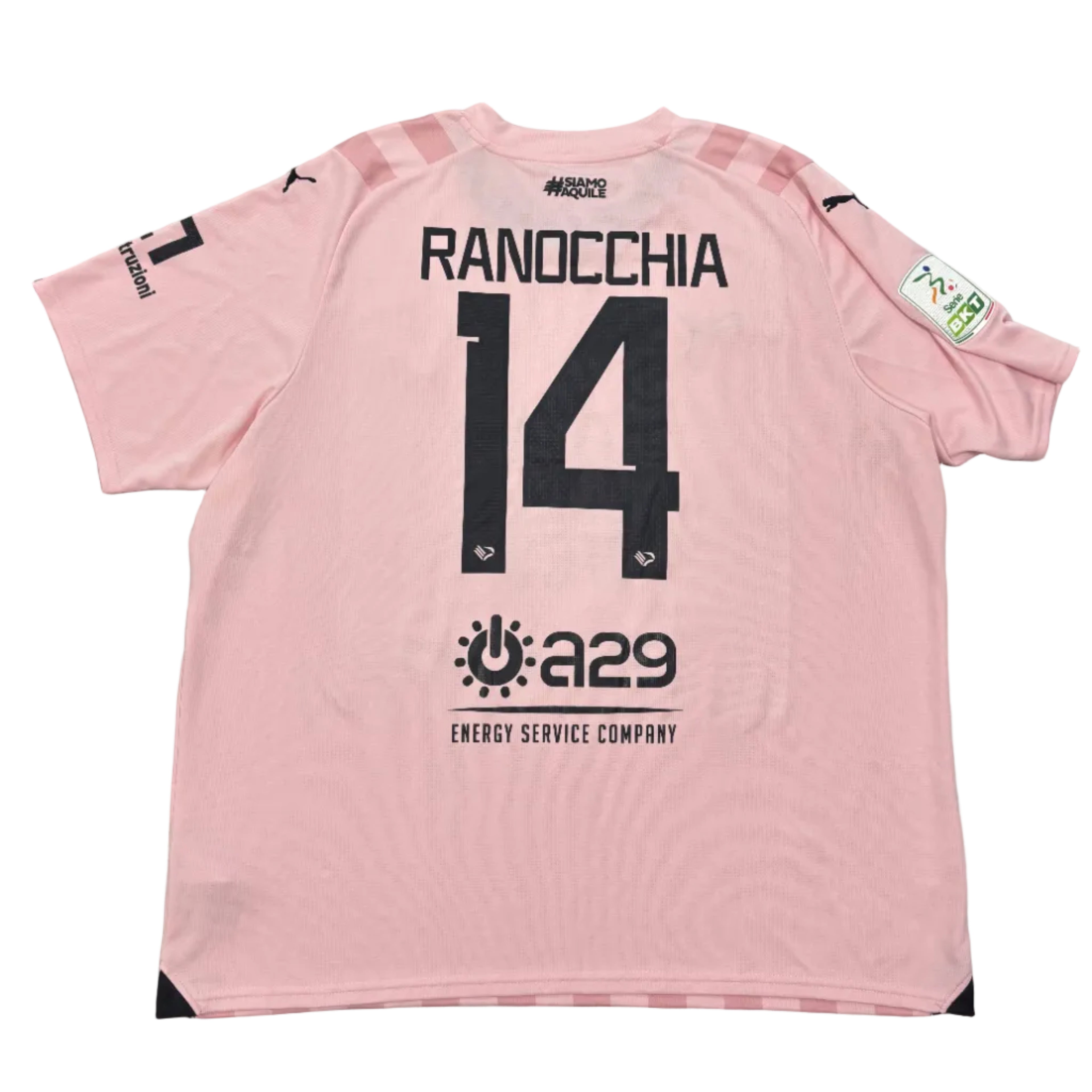 Pink sports jersey with 'RANOCCHIA 14' on a gray surface