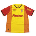 Yellow and red sports jersey with various logos on a round surface.