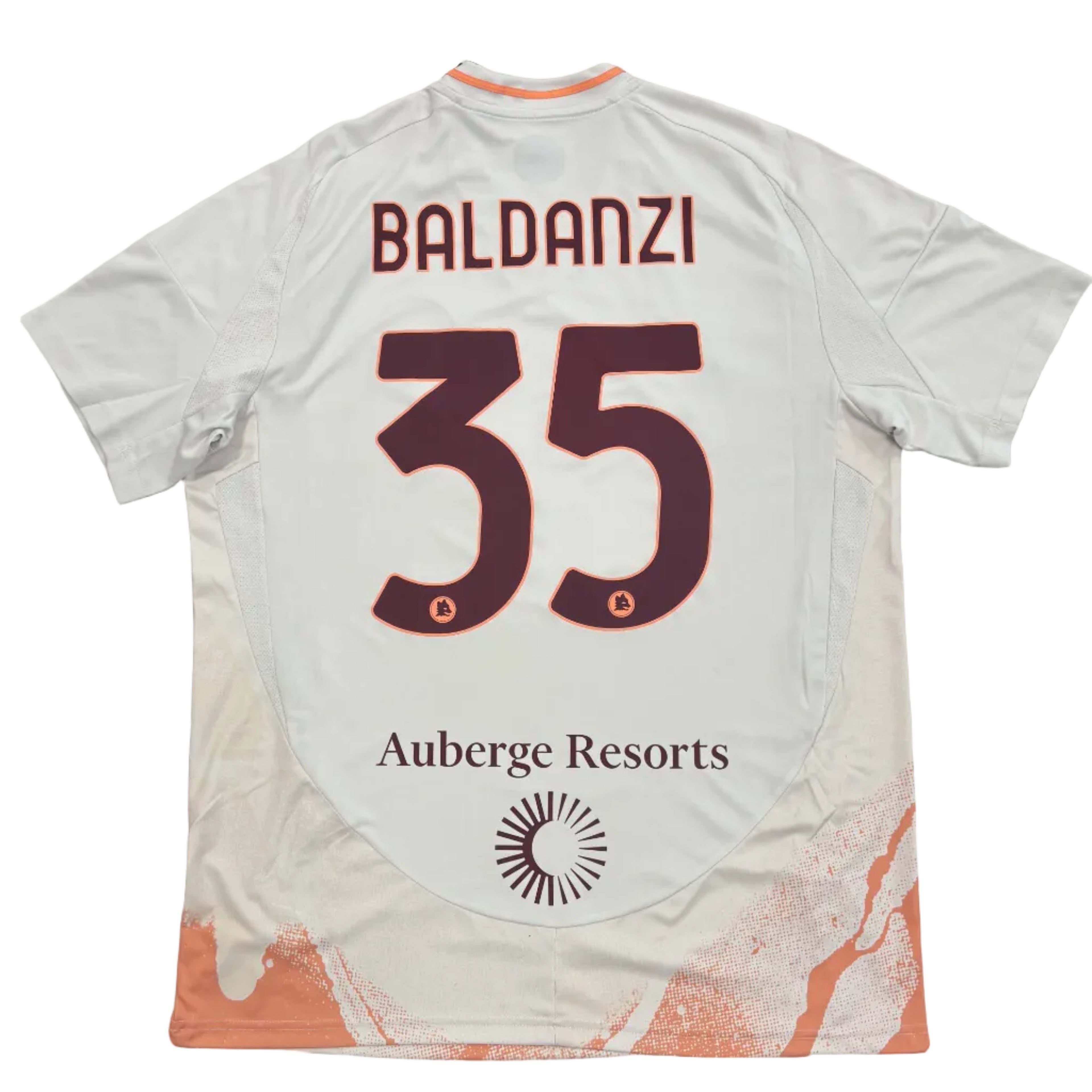 White t-shirt with 'Baldanzi' and number '35' on a round white table.