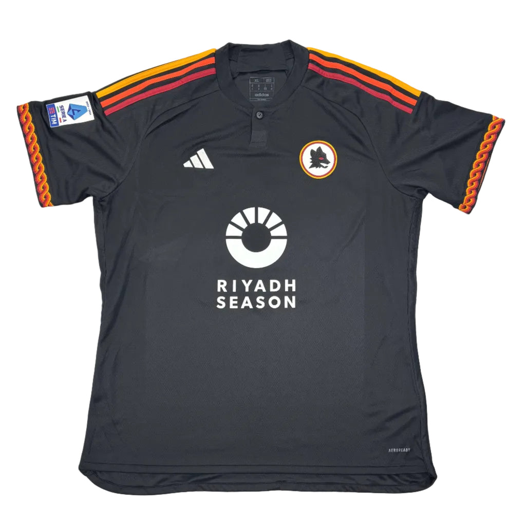 Black sports jersey with orange and red accents on a white surface