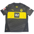 Gray and yellow sports jersey with branding on a round white table.