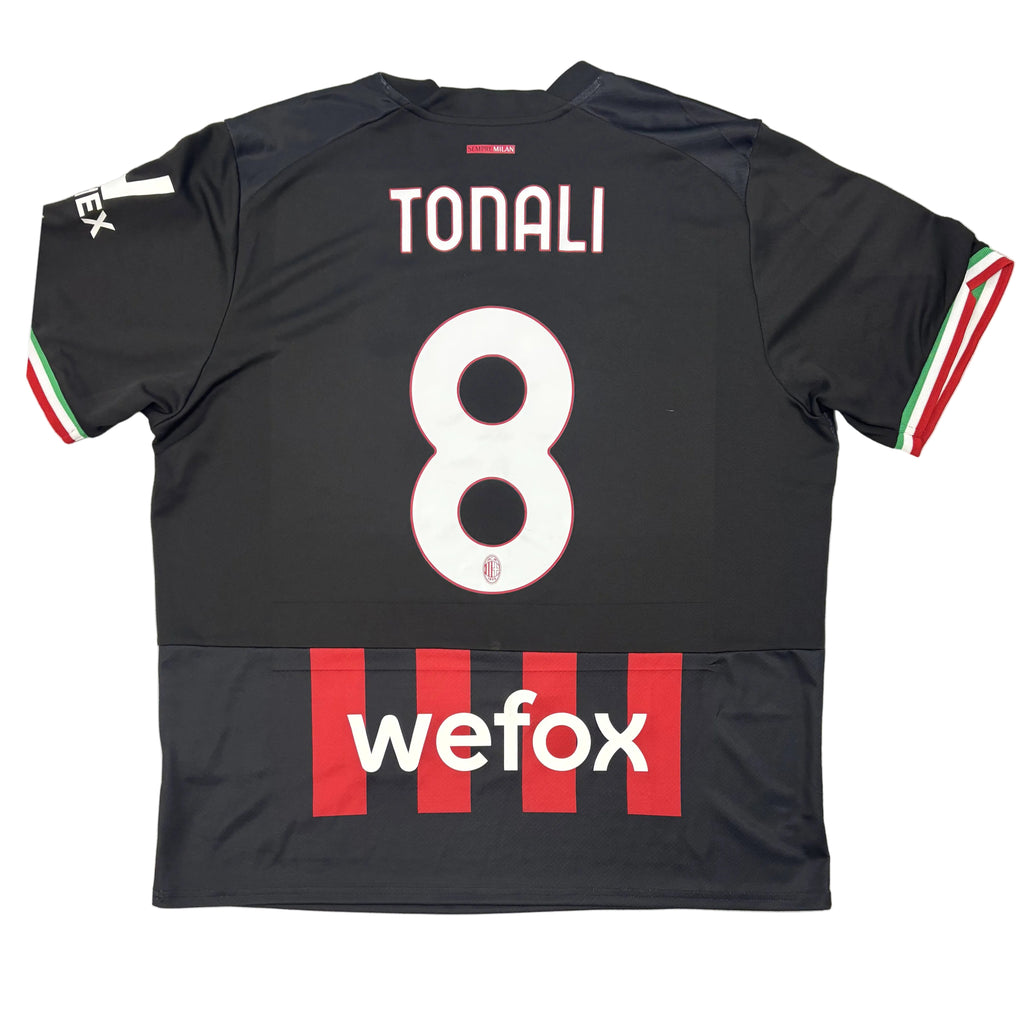 Black sports jersey with 'Tonali' and number '8', featuring 'wefox' branding, on a circular gray surface.