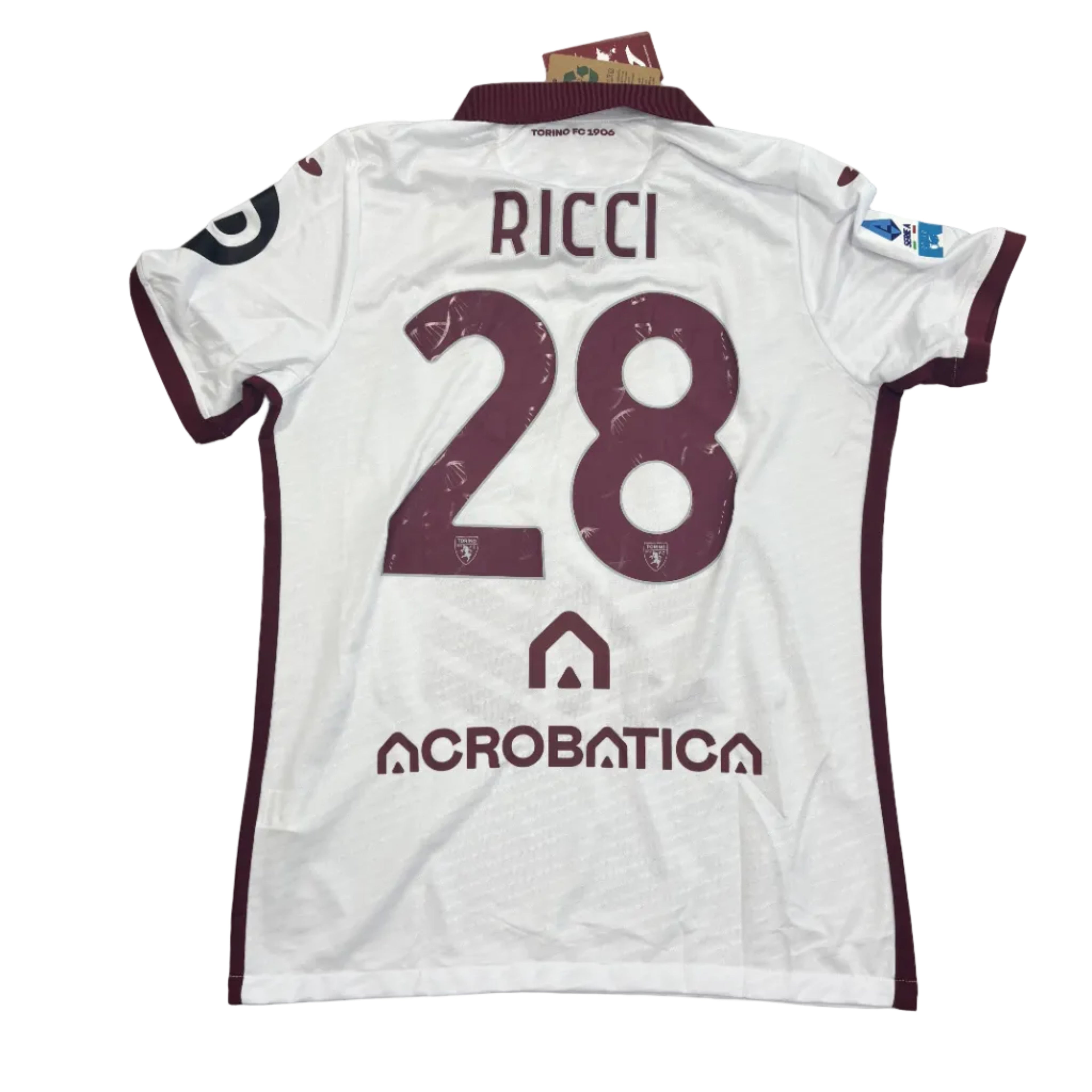 White sports jersey with maroon numbering and text on a gray surface