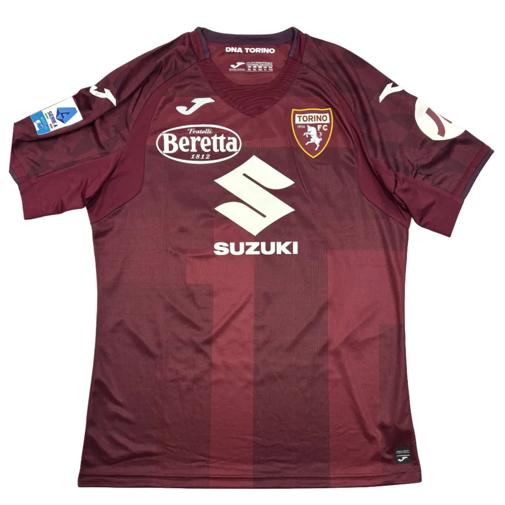 Maroon sports jersey with visible branding on a round white table.
