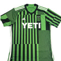 Green and black striped sports jersey with YETI logo on a round surface